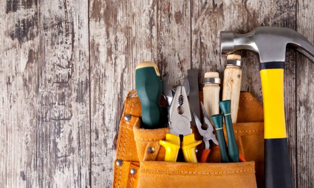 set of tools in tool box on a wooden background