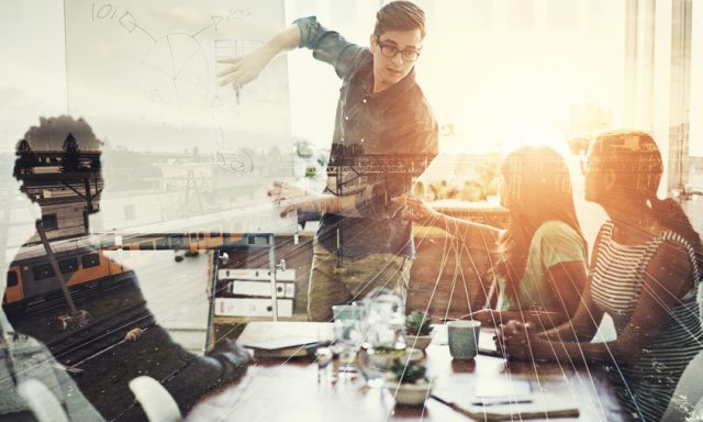 Multiple exposure shot of a business group superimposed over a train track