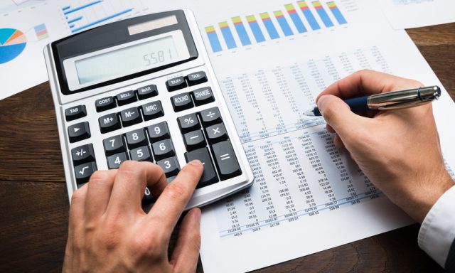 Businessman Analyzing Graph And Doing Financial Calculations